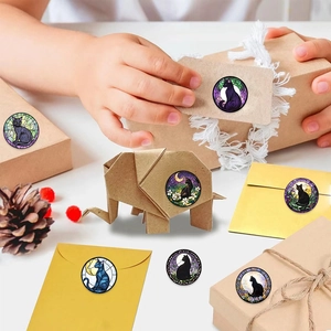 Detailed view of cat and moon stained glass stickers on gift boxes and envelopes