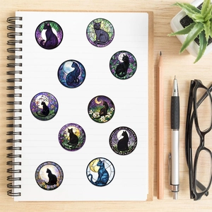 Stained glass style black cat and moon round stickers on a white spiral notebook