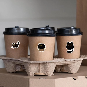 Black cat cartoon stickers applied on brown paper coffee cups in a pulp tray holder
