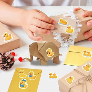 Cartoon yellow duck stickers applied on craft boxes and envelopes for DIY decoration