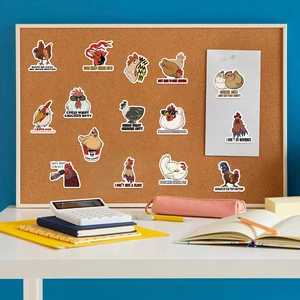 Cartoon chicken stickers with funny quotes displayed on a cork board workspace