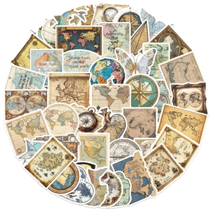 Close-up of vintage world map stickers with retro compass and motivational text details