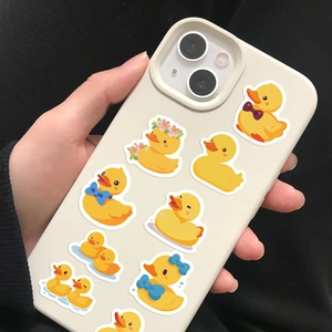 Close-up of cream phone case featuring cute yellow cartoon ducks for dual-lens iPhone