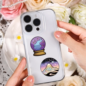 Close-up of waterproof transparent witch stickers on a phone case with aesthetic floral decor