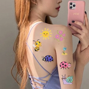 Detail of colorful cartoon insect temporary tattoos featuring bees and ladybugs for kids