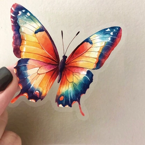 Autocollant papillon aquarelle vibrant en PET transparent tenu à la main