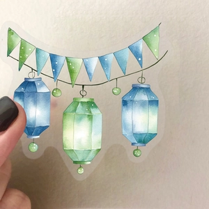 Close-up of translucent watercolor lantern sticker held by hand on PET material