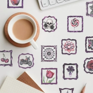 Macro shot of aesthetic purple glitter frame stickers with gothic and floral motifs