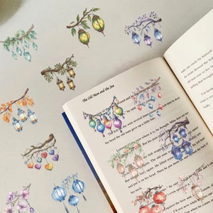 Detail of waterproof PET stickers with colorful lantern designs applied on book pages