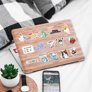 Funny internet meme stickers with shiba inu and goose designs on a wooden laptop cover