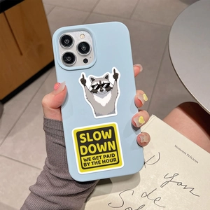 Handheld light blue phone case with raccoon illustration and Slow Down text sticker
