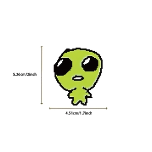 Detail showing dimensions of green cartoon alien sticker for laptops and luggage