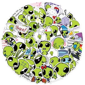 Close-up of assorted waterproof green alien doodle stickers for laptops and luggage