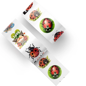 Macro shot of cartoon ladybug roll stickers featuring gnome and white LOVE text design