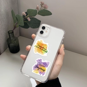 Close-up of transparent phone case with watercolor French inspirational quote art