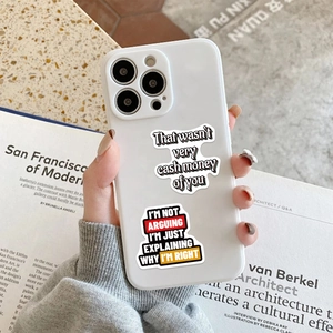 Minimalist white iPhone case with funny English meme stickers in a hand-held lifestyle shot