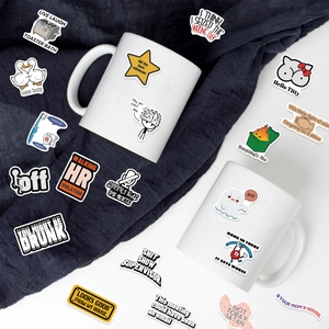Funny vinyl prank meme stickers showing waterproof application on a white ceramic mug