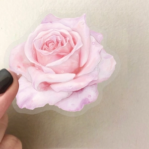 Hand holding a waterproof translucent pink rose flower sticker with watercolor petals