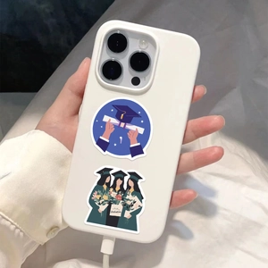 Close-up of waterproof graduation stickers on a white phone case being held by hand