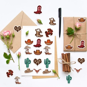 Close-up of Western Cowboy stickers on craft envelopes featuring boots and hats