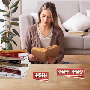 Detail of Chinese calligraphy magnetic bookmarks with red borders on wooden desk surface