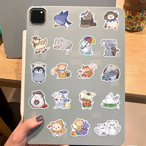 Close-up of cute cartoon animal stickers applied to a grey tablet for DIY decoration