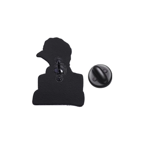 Macro view of the back of a black enamel bird pin with textured finish and rubber clutch