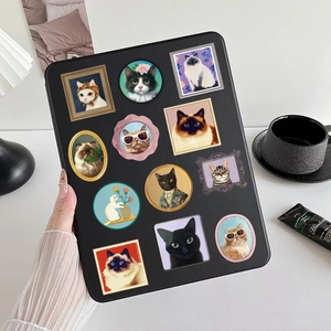 Artistic detail of a black tablet case featuring retro cat portraits and vintage gallery motifs