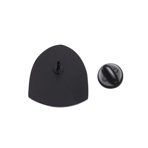 Macro detail of the matte black triangular metal badge back with rubber clutch pin