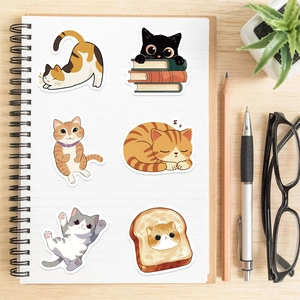 Close-up of cute cartoon cat stickers on notebook for DIY decoration and scrapbooking