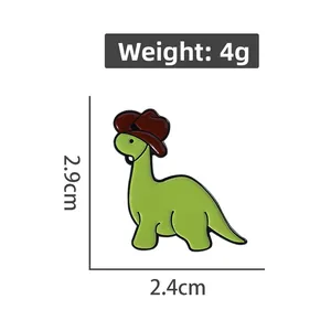 Cartoon green dinosaur enamel pin wearing a brown cowboy hat with 2.9cm x 2.4cm size specs