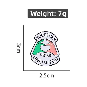Detail of dinosaur enamel pin measuring 3x2.5cm with Together We're Unlimited text