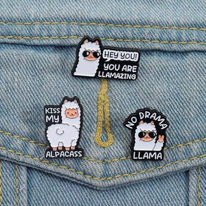Three cute cartoon alpaca enamel pins set featuring funny slogans on blue denim background