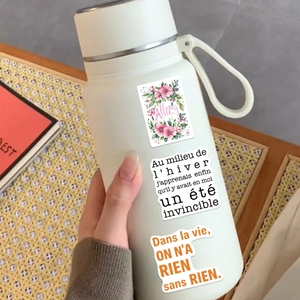 Waterproof French motivational stickers applied on a cream minimalist thermos bottle