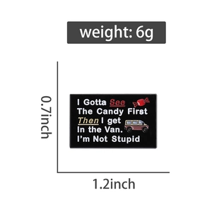 Detailed view of enamel pin with funny quote and candy van graphics on black background