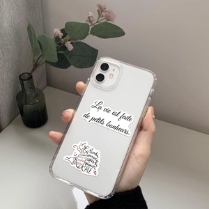 Detail of waterproof French stickers on a clear iPhone 11 case with hand-drawn coffee art
