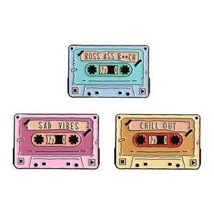 Three vintage cassette tape enamel pins set with retro phrases on white background