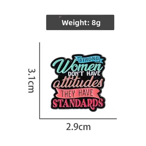 Detail of enamel pin with Strong Women text, showing dimensions 3.1cm and 2.9cm