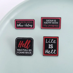 Set of four dark humor enamel pins with English quotes on a ceramic display plate