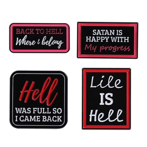 Set of four creative enamel pins with dark humor English quotes on black metal base