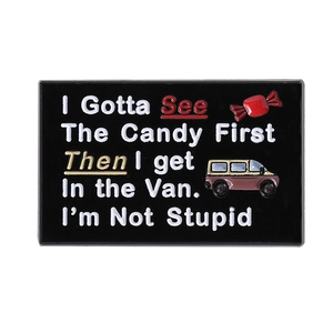 Black enamel brooch with funny candy and van graphic on a polished metal rectangle