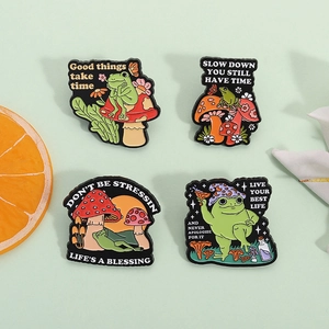 Set of four cute mushroom and frog enamel pins with motivational quotes for backpacks