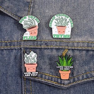 Set of four cute cartoon plant enamel pins with funny slogans on blue denim jacket