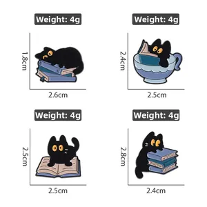 Detailed view of four black cat enamel pins featuring reading motifs and book dimensions