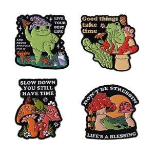 Set of four cute cartoon frog and mushroom enamel pins with inspirational phrases