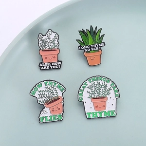 Set of four cartoon plant enamel pins with aloe and thyme designs on ceramic tray