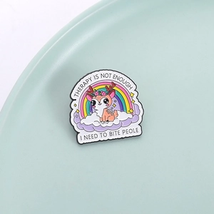 Cute rainbow deer enamel brooch pin with humorous text on a stylish tray display