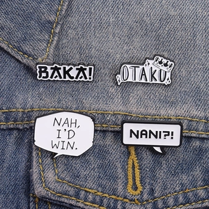 Close-up of four anime enamel pins with Baka and Otaku text on blue denim fabric