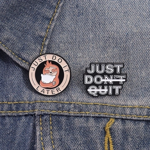 Cute enamel sloth brooch set with creative slogans on blue denim fabric background