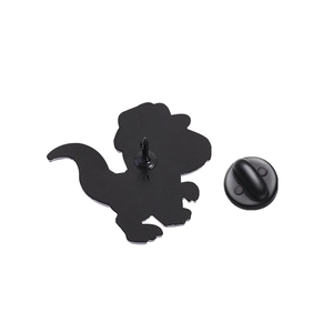 Detail view of the metal dinosaur badge back with black rubber clutch fastening
